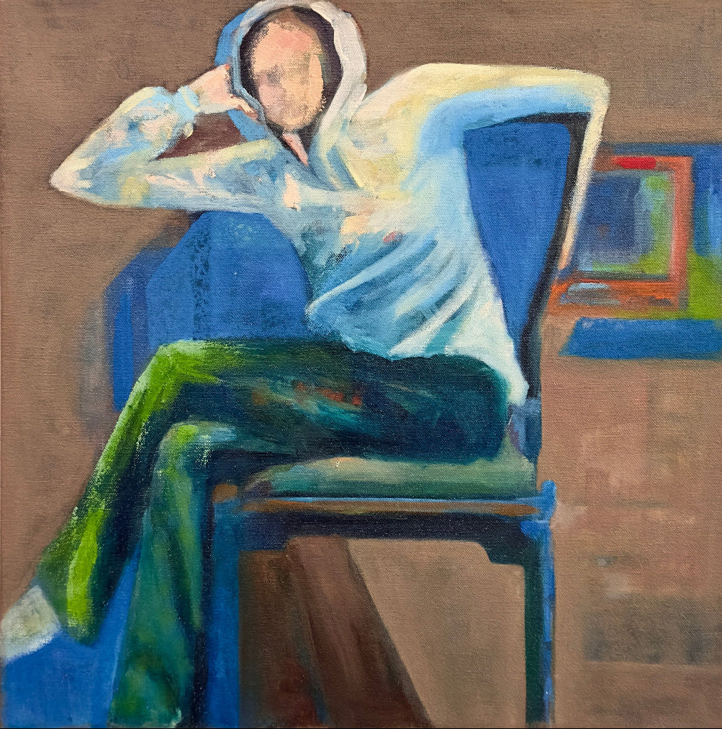 Person sitting on a blue chair wearing a white hoodie and green pants, with a brown background.
